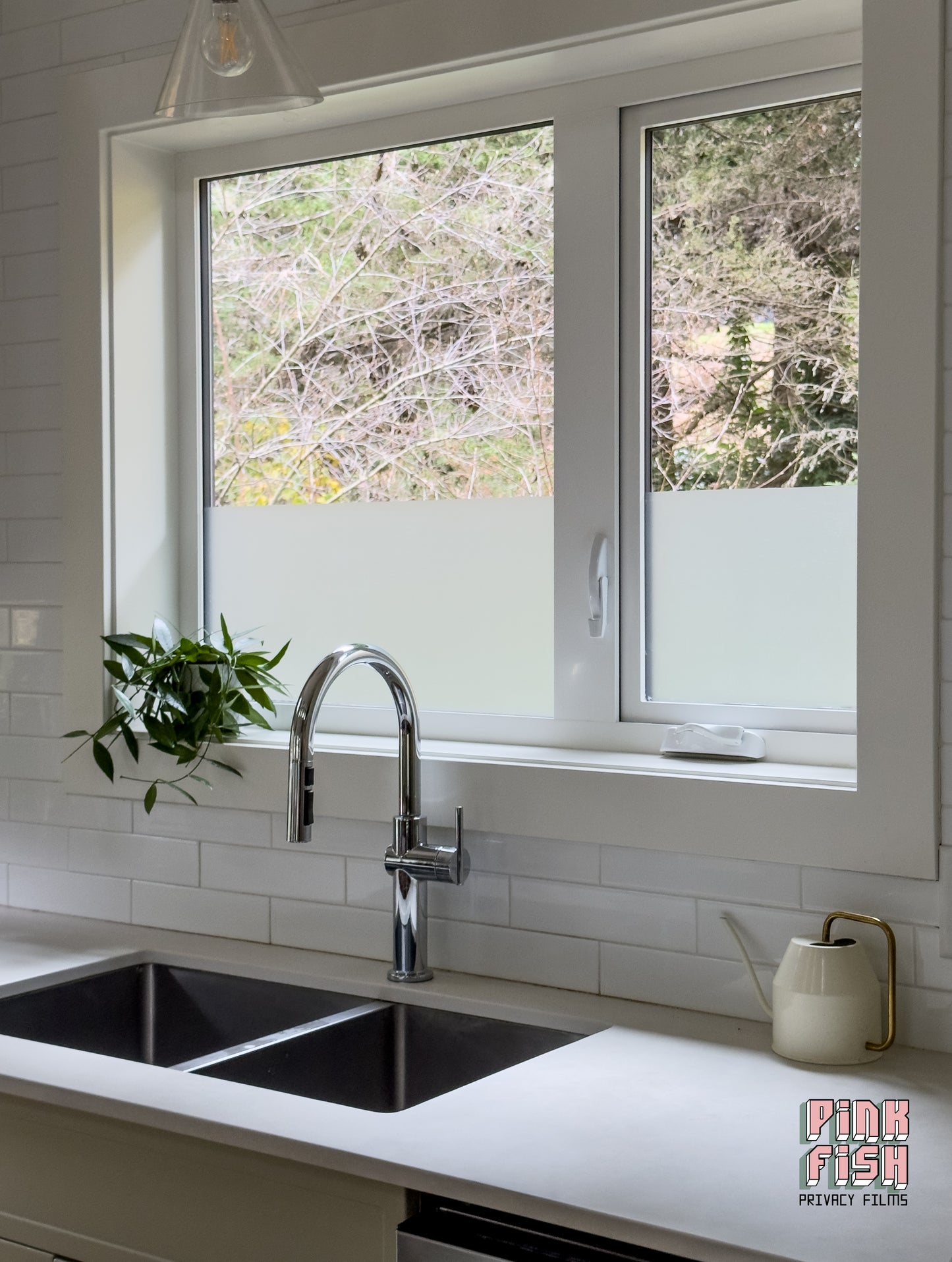 Modern kitchen with a double sink, faucet, and window with frosted glass.