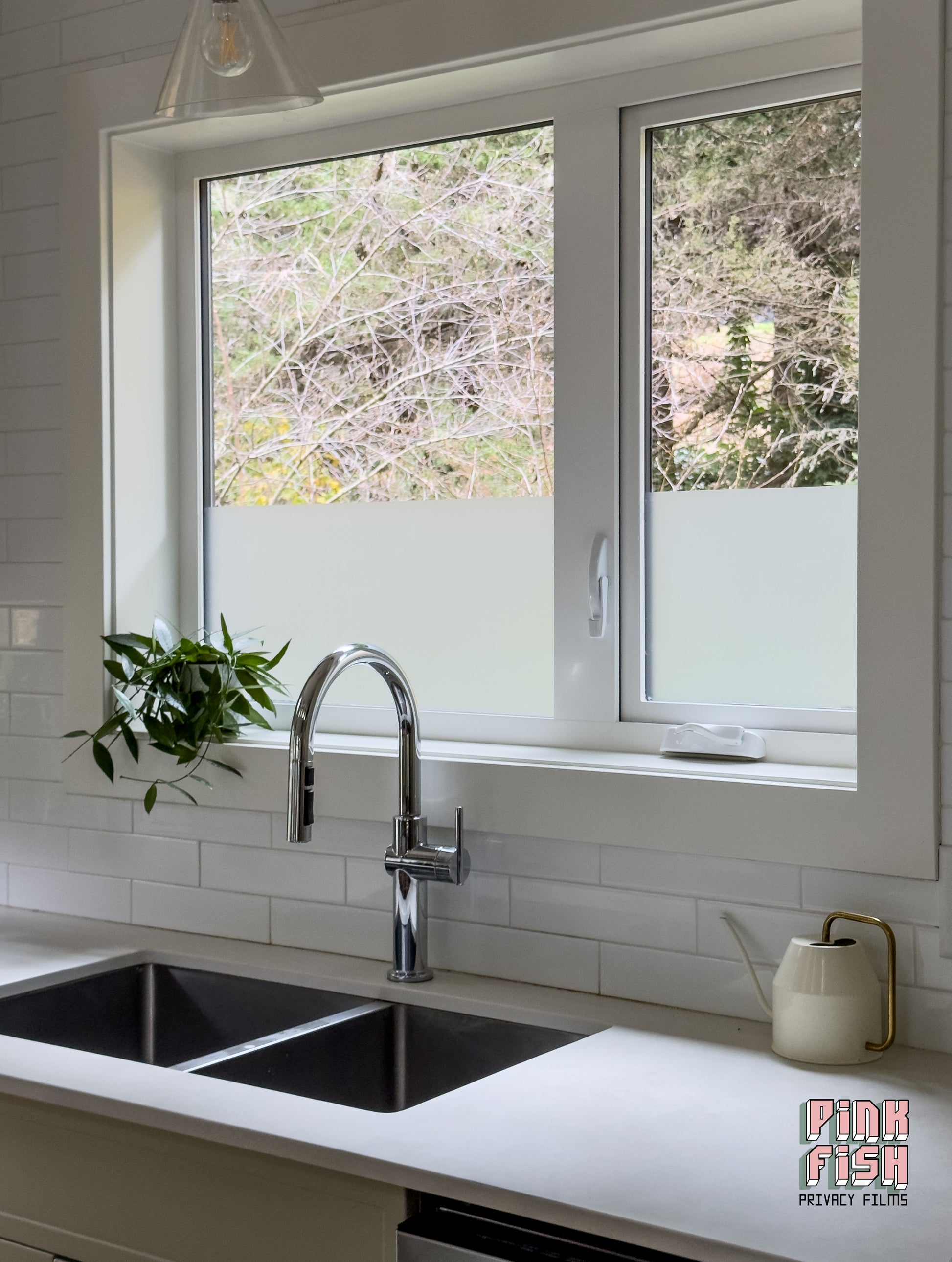Modern kitchen with a double sink, faucet, and window with frosted glass.